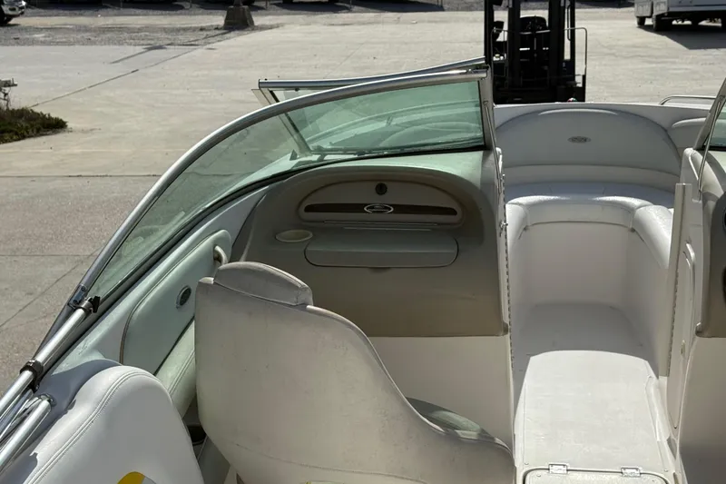 Slide: The Image of 2002 Chaparral 220 SSi boat interior with white seating and open windshield. - 12
