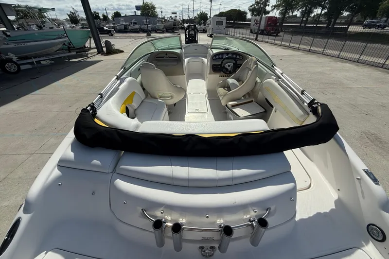 Slide: The Image of 2002 Chaparral 220 SSi boat interior with white seating and steering console. - 13