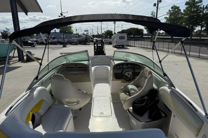 Slide: The Image of Interior view of a 2002 Chaparral 220 SSi boat with seating and steering wheel. - 15