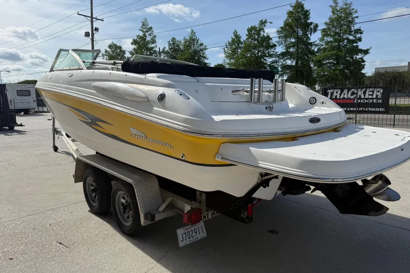 Slide: The Image of 2002 Chaparral 220 SSi boat on trailer, featuring yellow and white design. - 6