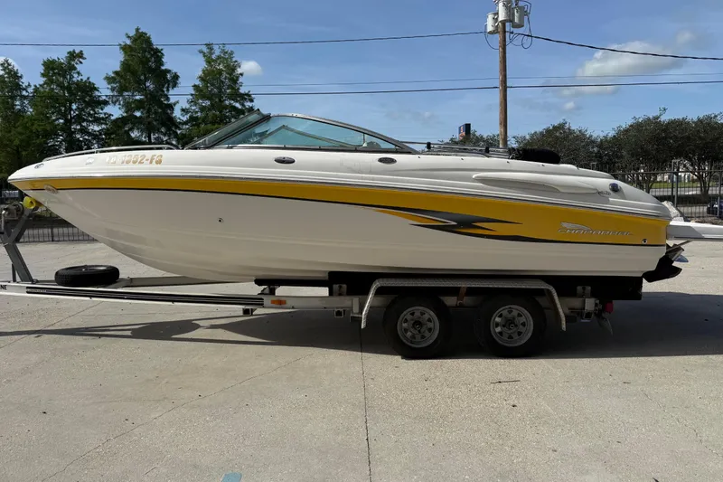 Slide: The Image of 2002 Chaparral 220 SSi boat on trailer, featuring yellow and white design. - 7
