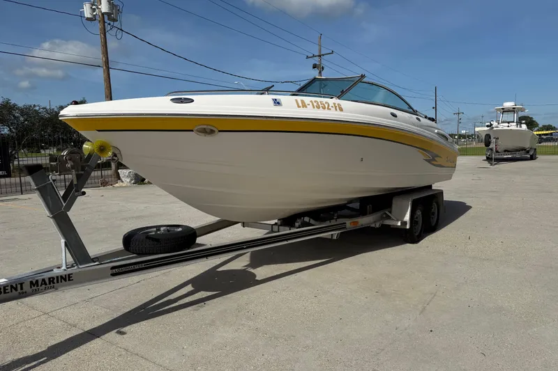 Slide: The Image of 2002 Chaparral 220 SSi boat on trailer in sunny outdoor setting. - 8