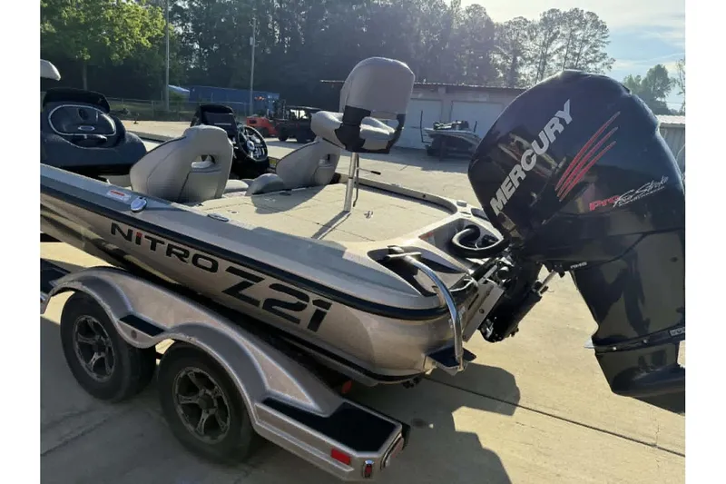 Slide: The Image of 2018 Nitro Z21 Pro boat with Mercury engine, parked on a trailer in a sunny outdoor setting. - 13