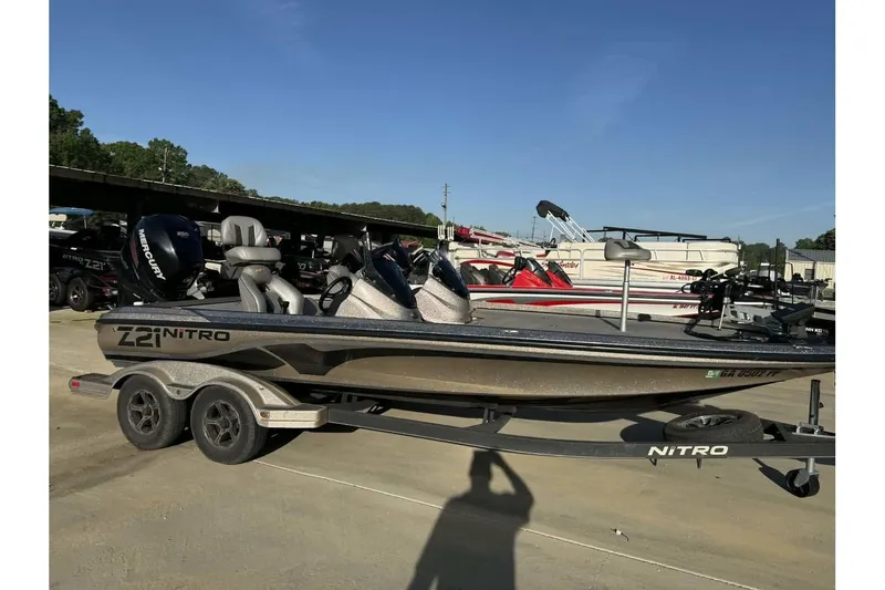 Slide: The Image of 2018 Nitro Z21 Pro boat on trailer, parked outdoors under clear blue sky. - 7