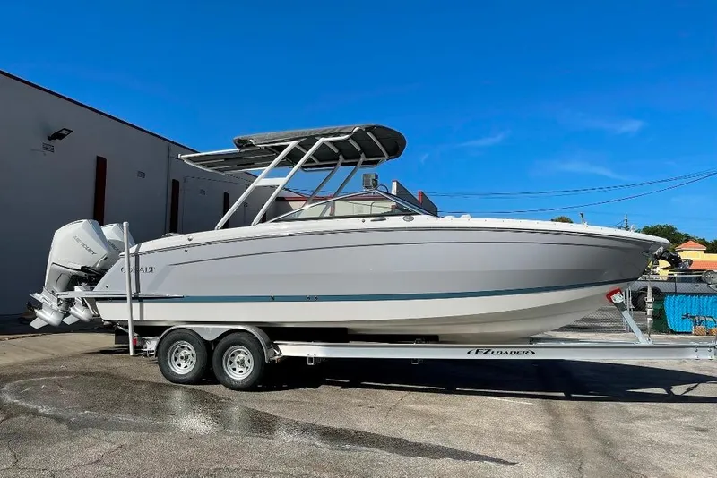 The Image of 2022 Cobalt R8 Outboard boat on trailer, parked outdoors under clear blue sky. - 1
