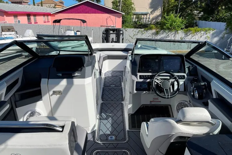 Slide: The Image of Interior view of a 2022 Cobalt R8 Outboard boat with modern dashboard and seating. - 10