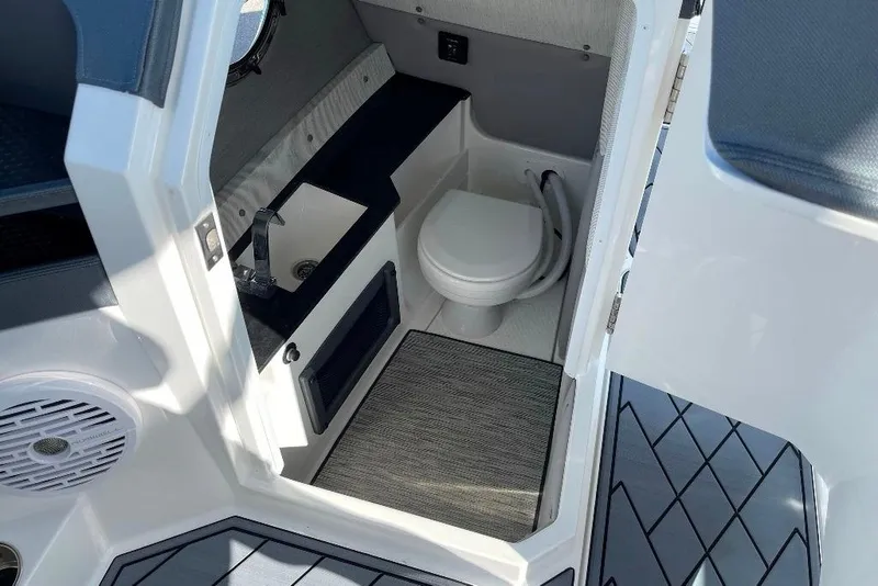 Slide: The Image of 2022 Cobalt R8 Outboard boat interior with compact bathroom and sink. - 12