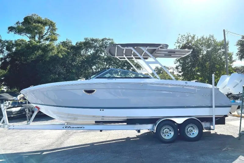 Slide: The Image of 2022 Cobalt R8 Outboard boat on trailer, parked outdoors under clear sky. - 4