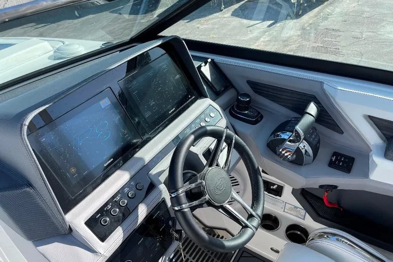 Slide: The Image of 2022 Cobalt R8 Outboard boat dashboard with steering wheel and digital displays. - 9