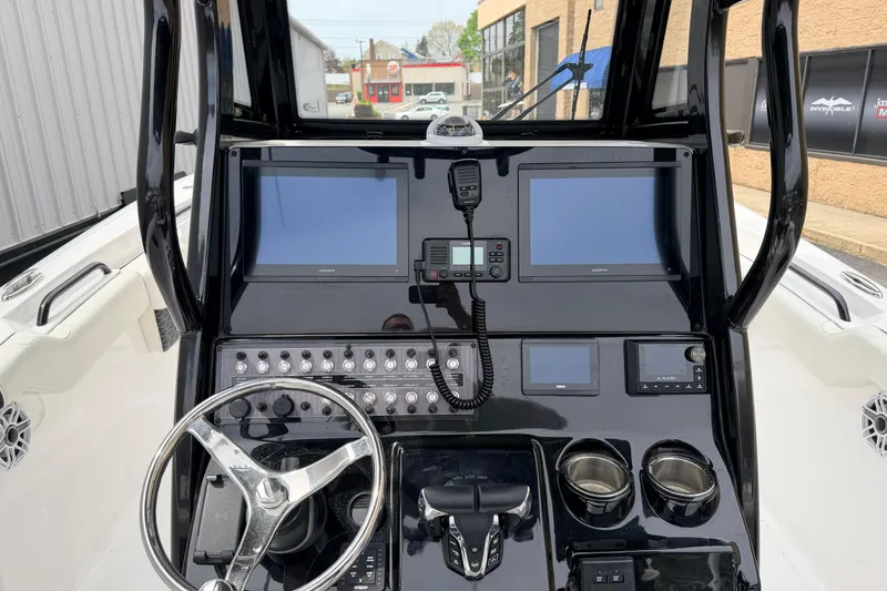 Slide: The Image of 2024 Tidewater 256 LXF boat dashboard with modern navigation and control systems. - 10