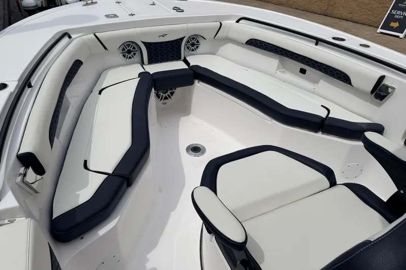 Slide: The Image of Luxurious seating area on 2024 Tidewater 256 LXF boat, featuring sleek white and black upholstery. - 13