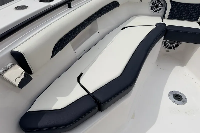 Slide: The Image of 2024 Tidewater 256 LXF boat interior with stylish seating and speaker system. - 14