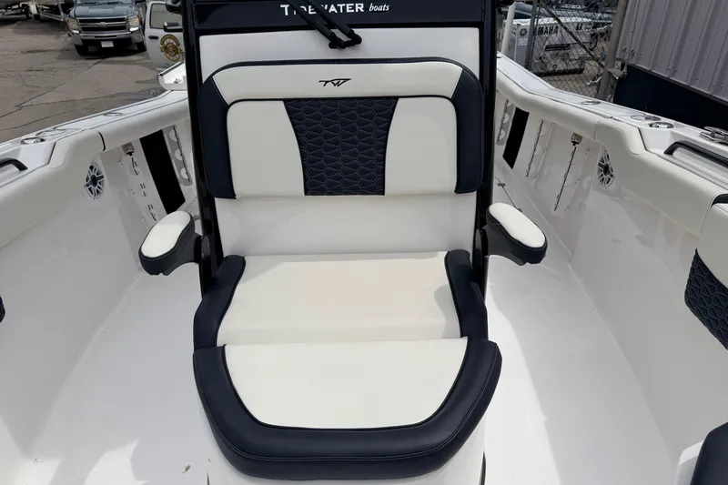 Slide: The Image of 2024 Tidewater 256 LXF boat seat with elegant white and navy upholstery. - 15