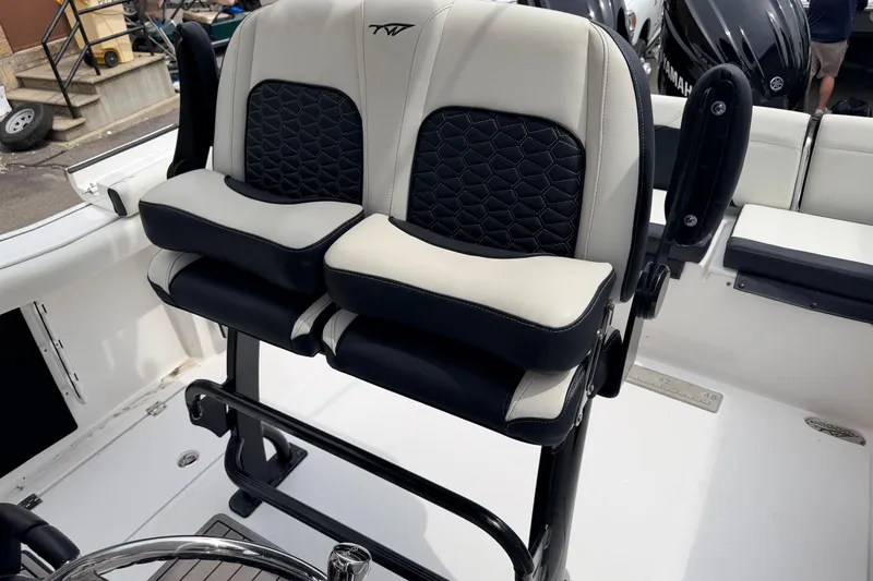 Slide: The Image of 2024 Tidewater 256 LXF boat seats with black and white upholstery. - 16
