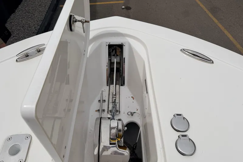 Slide: The Image of 2024 Tidewater 256 LXF boat anchor compartment with open hatch and fittings. - 18