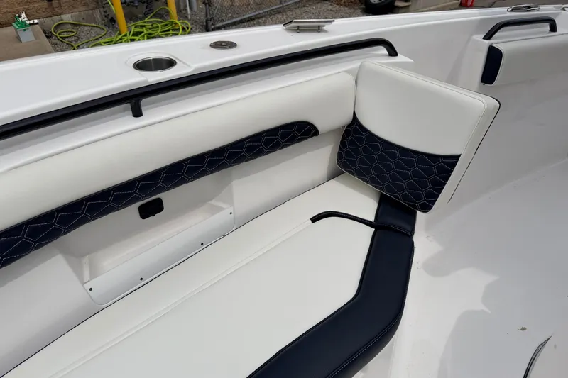Slide: The Image of 2024 Tidewater 256 LXF boat interior with stylish white and navy seating. - 22