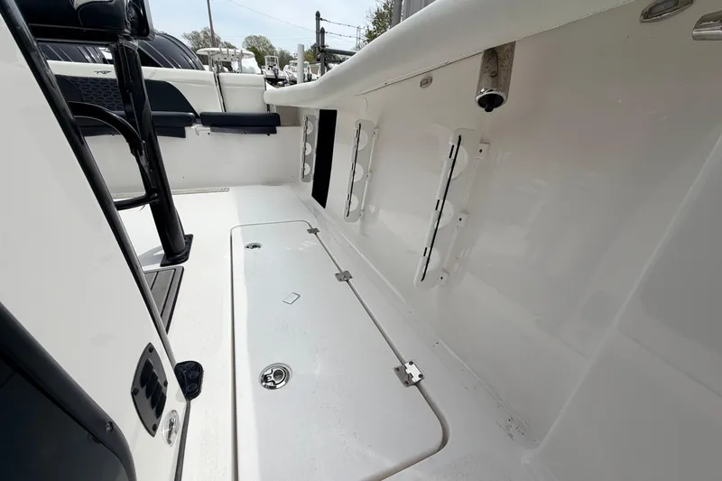 Slide: The Image of 2024 Tidewater 256 LXF boat interior, featuring sleek white deck and seating area. - 23