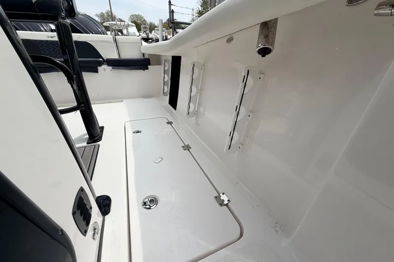 Slide: The Image of 2024 Tidewater 256 LXF boat interior, showcasing sleek seating and storage compartments. - 25