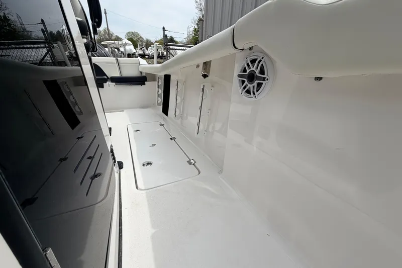 Slide: The Image of 2024 Tidewater 256 LXF boat interior with sleek white deck and built-in speaker. - 26