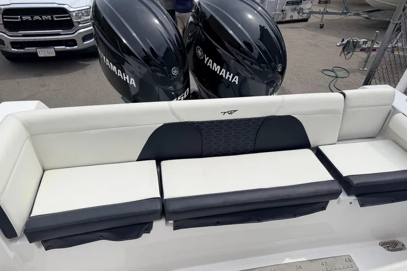 Slide: The Image of 2024 Tidewater 256 LXF boat with Yamaha engines and cushioned seating. - 30
