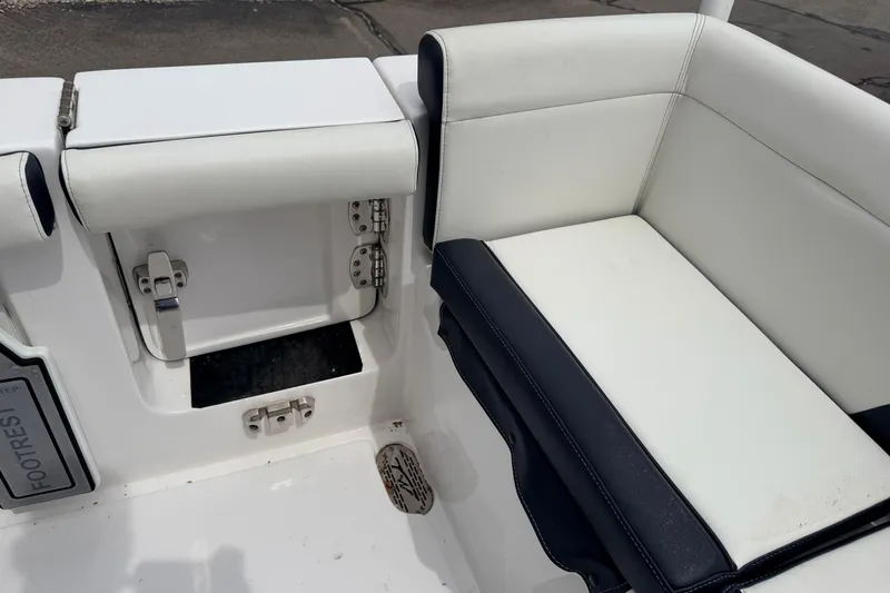 Slide: The Image of 2024 Tidewater 256 LXF boat seating area with white and black upholstery. - 32
