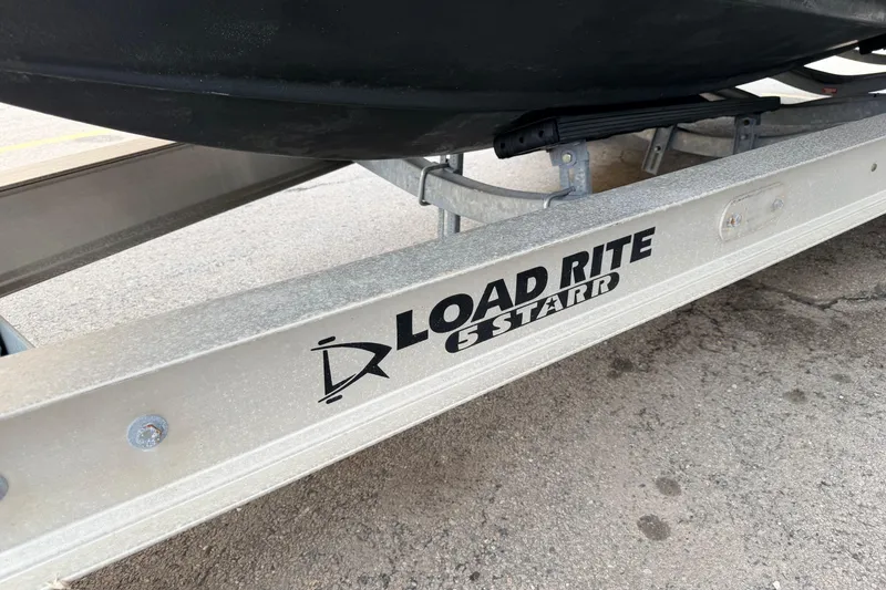 Slide: The Image of Trailer for 2024 Tidewater 256 LXF boat, featuring Load Rite 5 Starr branding. - 34