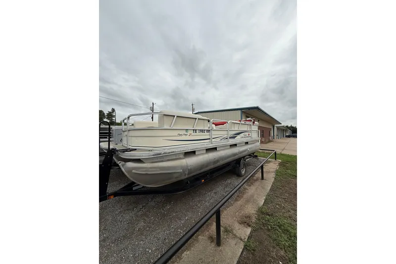 Slide: The Image of 2007 Sun Tracker Party Barge 21 Signature Series pontoon boat on trailer, overcast sky. - 2
