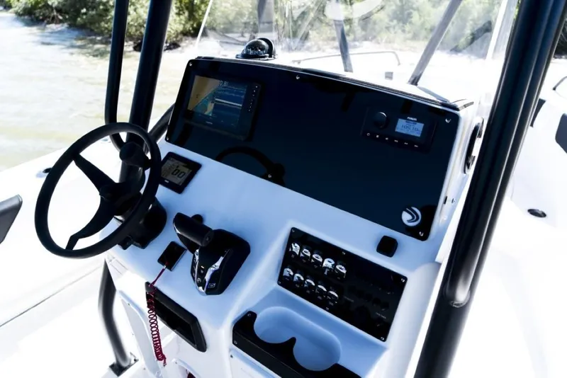 Slide: The Image of 2025 Edgewater 208CC Watchman boat dashboard with steering wheel and control panel. - 14