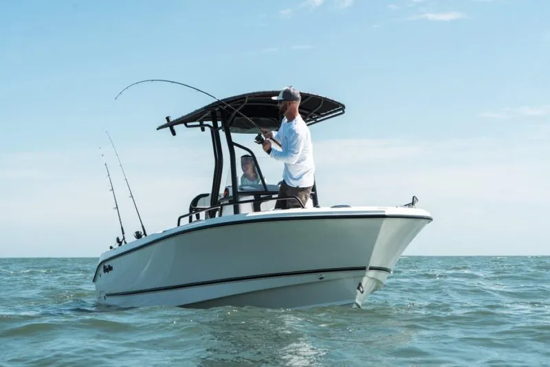 Slide: The Image of Man fishing on 2025 Edgewater 208CC Watchman boat in open water. - 9