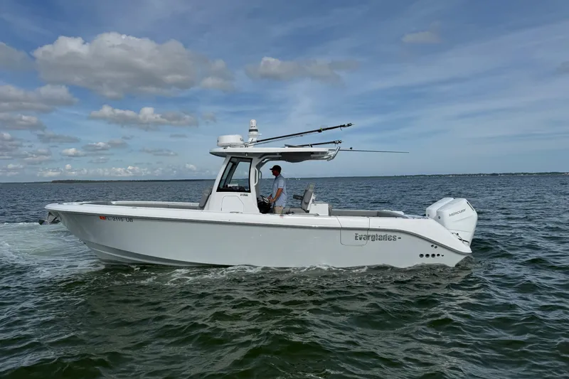 The Image of 2025 Everglades 315 Center Console boat cruising on open water under a clear sky. - 1
