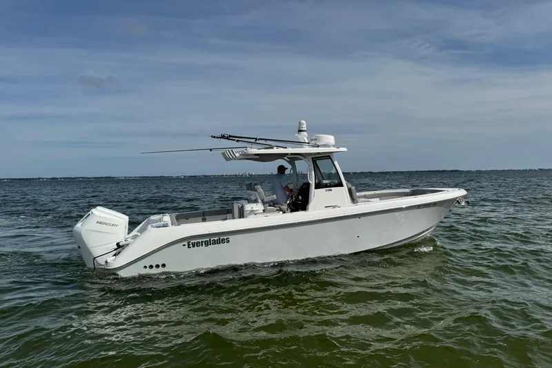 Slide: The Image of 2025 Everglades 315 Center Console boat cruising on open water. - 10