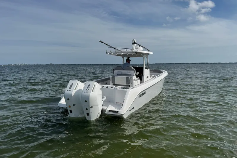 Slide: The Image of 2025 Everglades 315 Center Console boat on open water, featuring dual 400 V10 engines. - 11