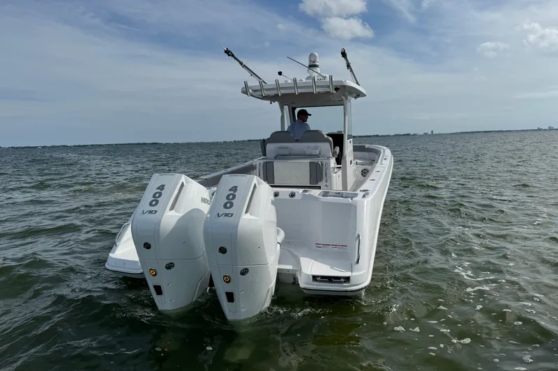 Slide: The Image of 2025 Everglades 315 Center Console boat with twin 400 V10 engines on open water. - 13