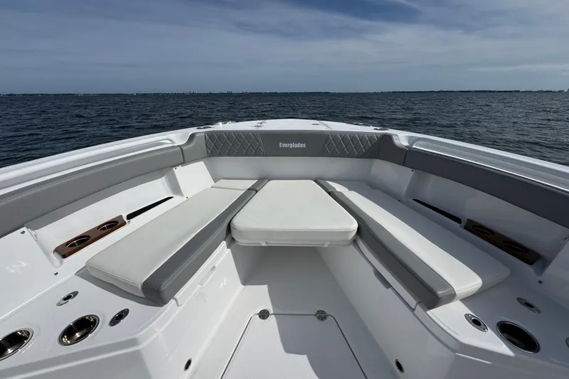 Slide: The Image of 2025 Everglades 315 Center Console boat interior with cushioned seating on open water. - 15