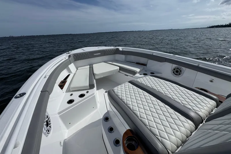 Slide: The Image of 2025 Everglades 315 Center Console boat interior with luxurious seating on open water. - 16