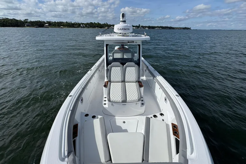 Slide: The Image of 2025 Everglades 315 Center Console boat on open water, featuring sleek design and modern amenities. - 18