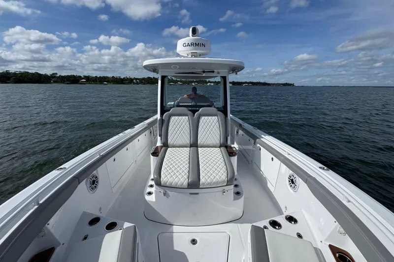 Slide: The Image of 2025 Everglades 315 Center Console boat on open water under a cloudy sky. - 19