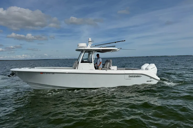 Slide: The Image of 2025 Everglades 315 Center Console boat cruising on open water. - 2