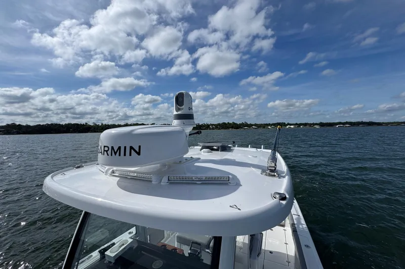 Slide: The Image of 2025 Everglades 315 Center Console boat on water under blue sky. - 20