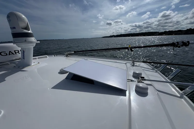 Slide: The Image of 2025 Everglades 315 Center Console boat on water, featuring advanced navigation equipment. - 21