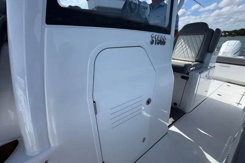 Slide: The Image of 2025 Everglades 315 Center Console boat interior with seating and storage compartment. - 22