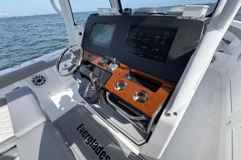 Slide: The Image of 2025 Everglades 315 Center Console boat dashboard with modern controls and ocean view. - 26