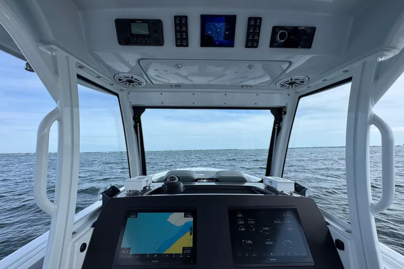 Slide: The Image of Interior view of 2025 Everglades 315 Center Console boat with navigation screens. - 27
