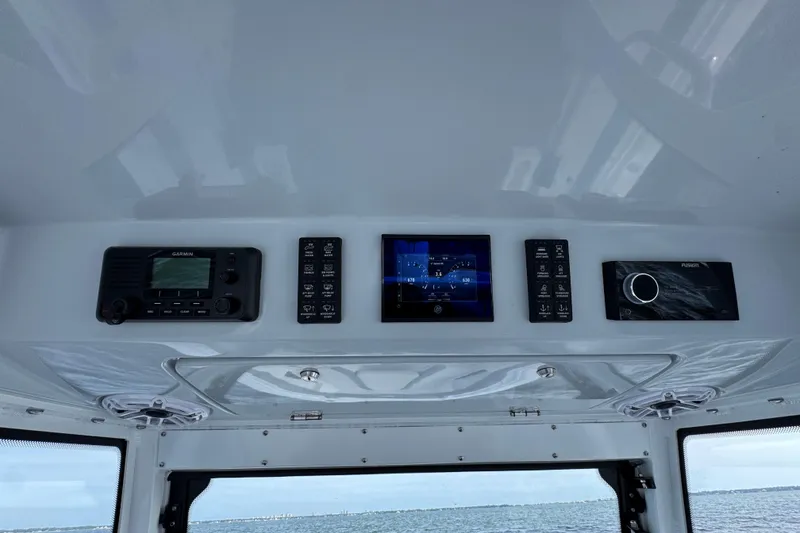 Slide: The Image of Control panel of 2025 Everglades 315 Center Console boat with navigation and audio systems. - 28