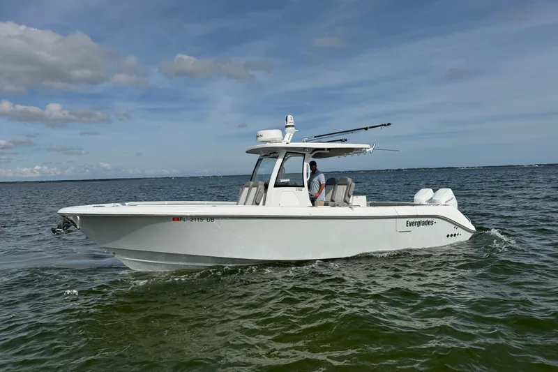 Slide: The Image of 2025 Everglades 315 Center Console boat cruising on open water. - 3