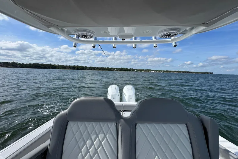 Slide: The Image of 2025 Everglades 315 Center Console boat on open water, featuring dual engines and luxury seating. - 31