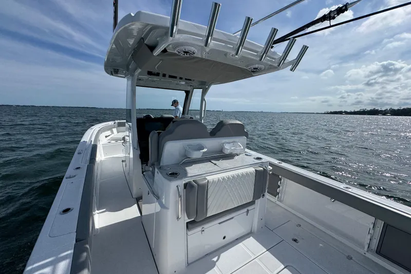 Slide: The Image of 2025 Everglades 315 Center Console boat on open water, featuring spacious deck and seating. - 33