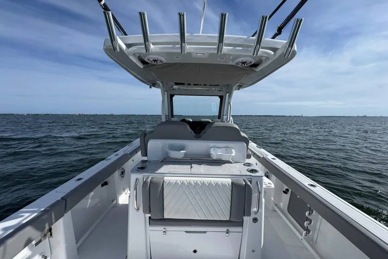 Slide: The Image of 2025 Everglades 315 Center Console boat on open water, showcasing sleek design and spacious deck. - 34