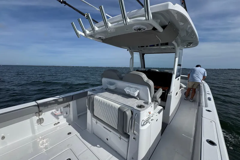 Slide: The Image of 2025 Everglades 315 Center Console boat on open water, featuring spacious deck and modern design. - 35