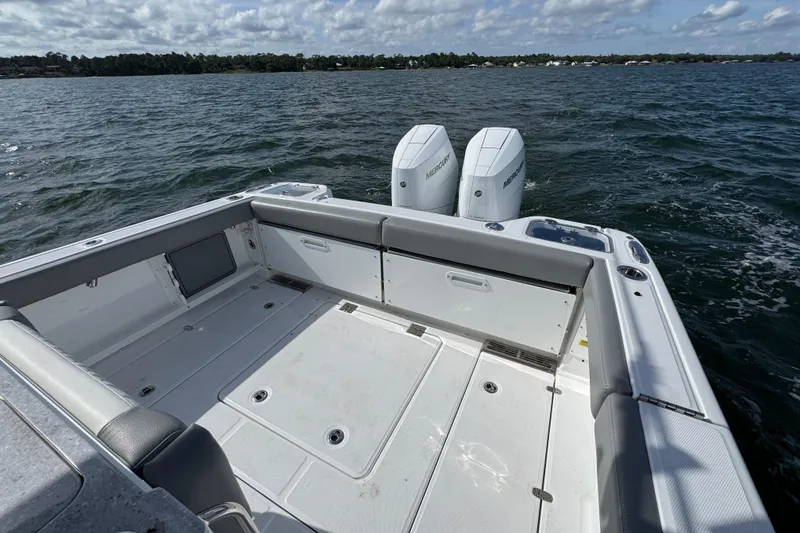 Slide: The Image of 2025 Everglades 315 Center Console boat with dual Mercury engines on open water. - 37